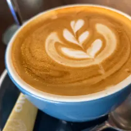 Latte art in a blue cup